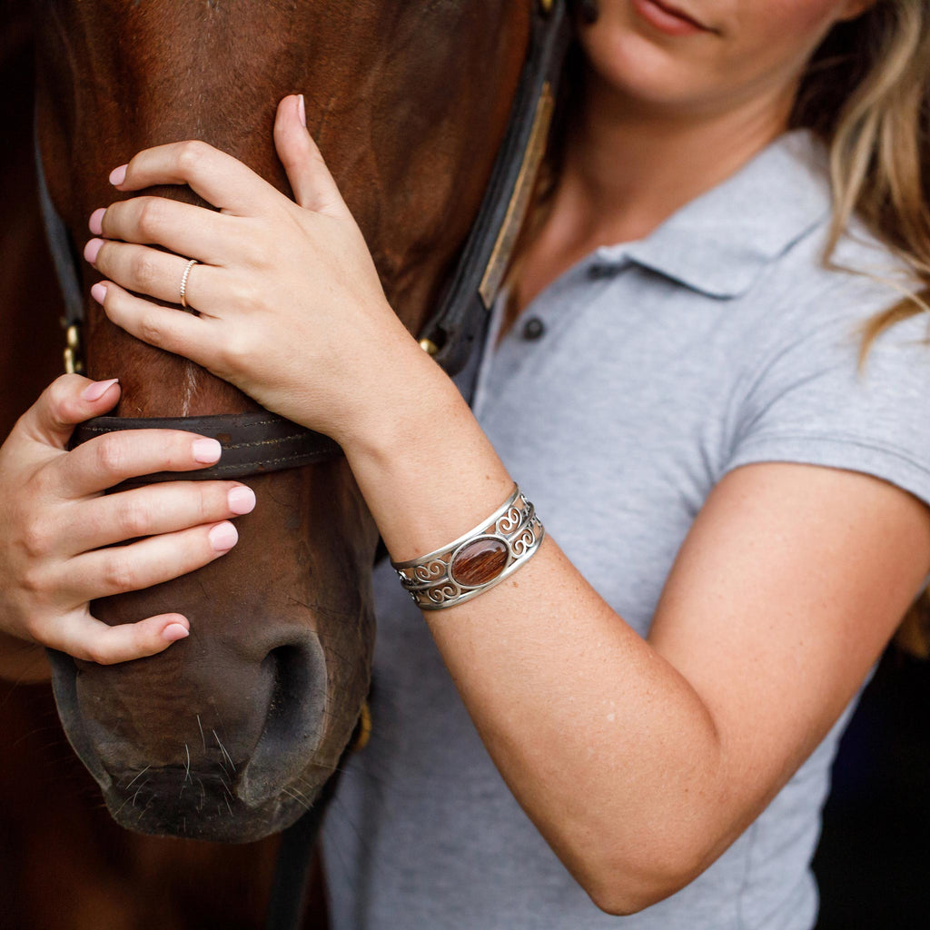 woman hugging horse's nose wearing the ailin horse hair cuff bracelet